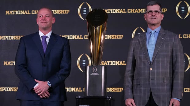 Washington’s Kalen DeBoer, Michigan’s Jim Harbaugh pose in front of 2024 College Football Playoff trophy.